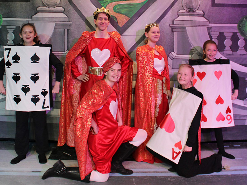 Don’t miss the action in BRCT’s “Alice in Wonderland,” performing now through February 9. Here, the King of Hearts (Xander Pasley, center left, standing) and the Queen of Hearts (Amelia Thomas, center right, standing) are surrounded by their subjects, the 7 of Spades (Maddie Boyce), the Knave of Hearts (Faith Mann, kneeling), the Ace of Hearts (Hannah Sheilds) and the 6 of Hearts (Abigail Shields).