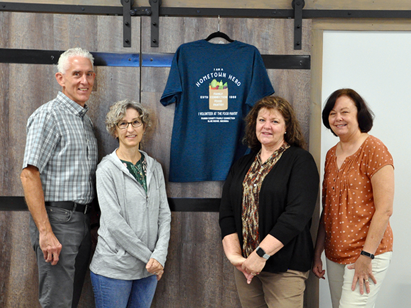 Fannin County Family Connection volunteers were treated to a large lunch and were gifted T-shirts Friday, September 25. Shown next to a shirt is, from left, Tom and Nancy Niswander, Priscilla McDonald and Kathy Jones.