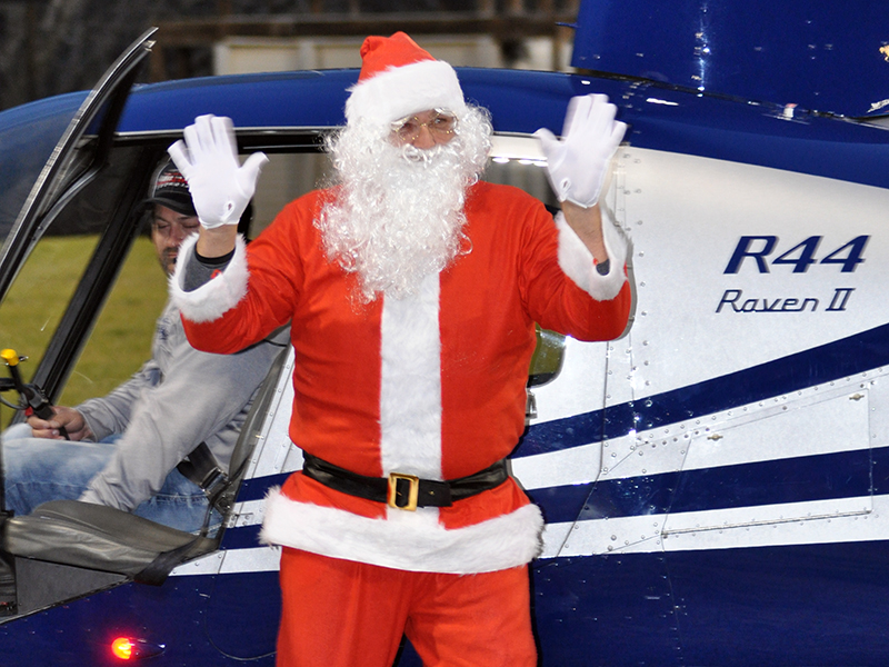 Santa Claus waves to everyone as he steps out of the helicopter that carried him to his visit at the Fannin County Recreation Center.