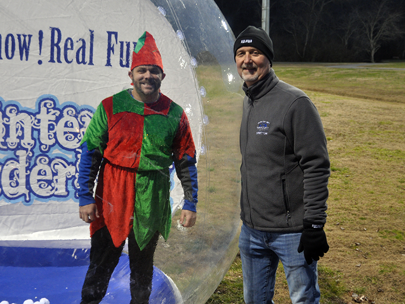 Santa’s helper Tim Towe took up his duties in a snow globe next to Fannin Recreation Department Director Eddie O’Neal during Santa’s visit to the Fannin County Recreation Center Wednesday, December 23.