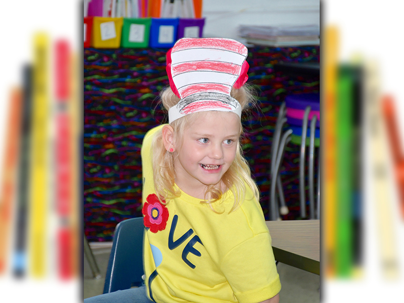 West Fannin Elementary School student Summer Cockerham smiles big as she gets ready for another Dr. Seuss story during Read Across America Week.