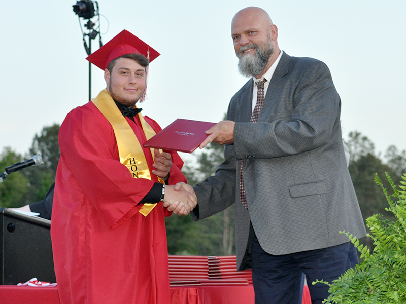 Joseph Johnson is all smiles as he receives his diploma from Polk County Director of Schools Dr. James Jones during Copper Basin’s graduation ceremony Thursday, May 20.
