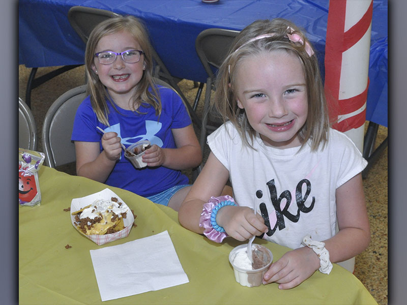 Maggie Nazerian, left and Millie Nazerian enjoy a meal at Vacation Bible School hosted by Pleasant Hill Baptist Church Wednesday, June 9.