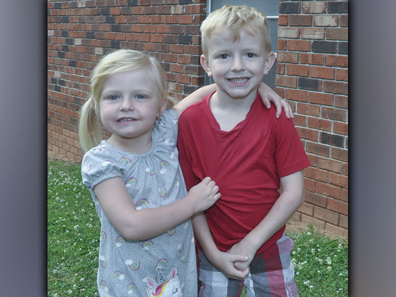 Jacquelyn and Luke Patterson are all smiles as they head to play outside during Pleasant Hill Baptist Church’s VBS Wednesday, June 9.