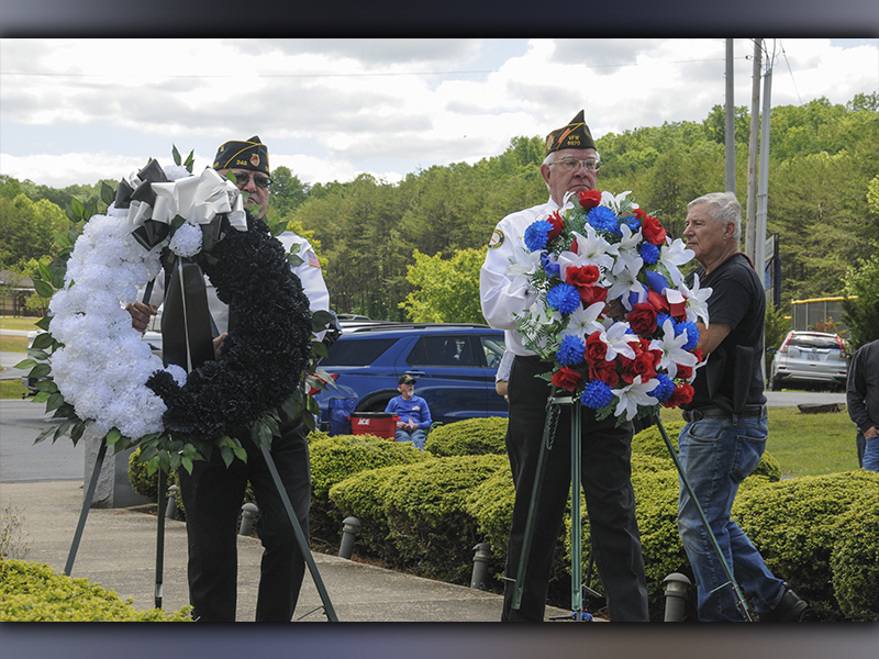 Richard Crosley (left) and Ron Wallace placed wreaths during the Memorial Day ceremony Monday at Veterans Memorial Park.