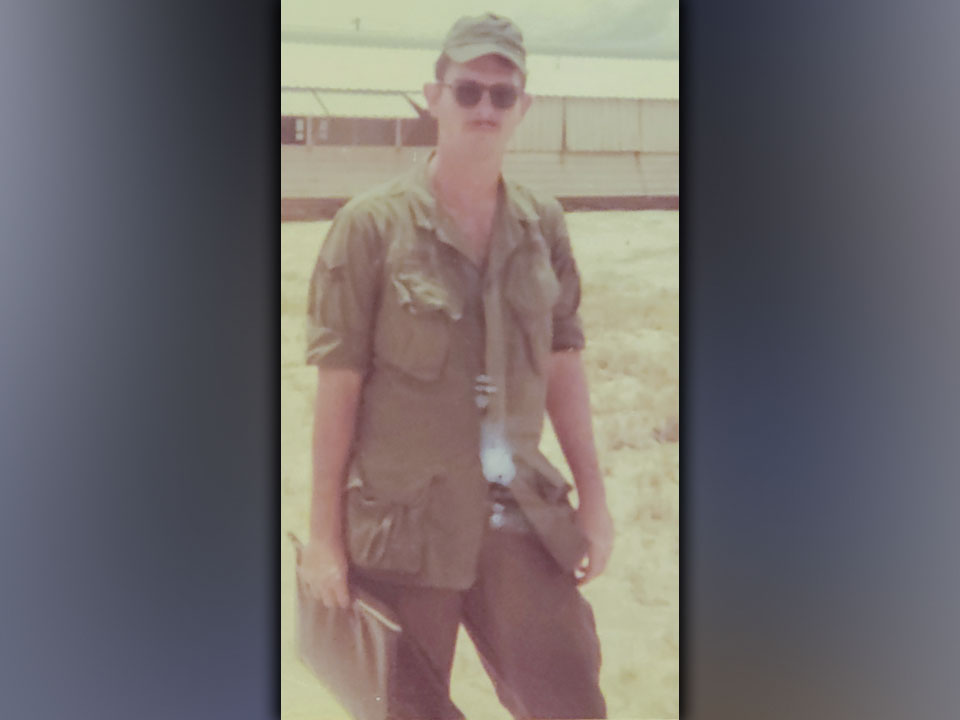 Air Force veteran Ken Campbell stops for a picture on his last day in Vietnam.