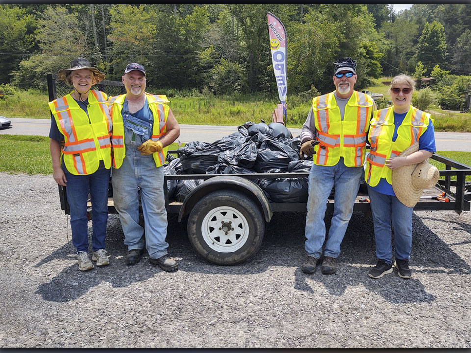 After five hours of cleaning up trash, the four member team collected over 30 bags of trash weighing approximately 750 pounds. Shown are, from left, Patty Freeman, Ronney Freeman, Jeff Thomason and Dee Dee Deal of Turtletown who came together Saturday, July 24, to pick up trash along Runion Road.  