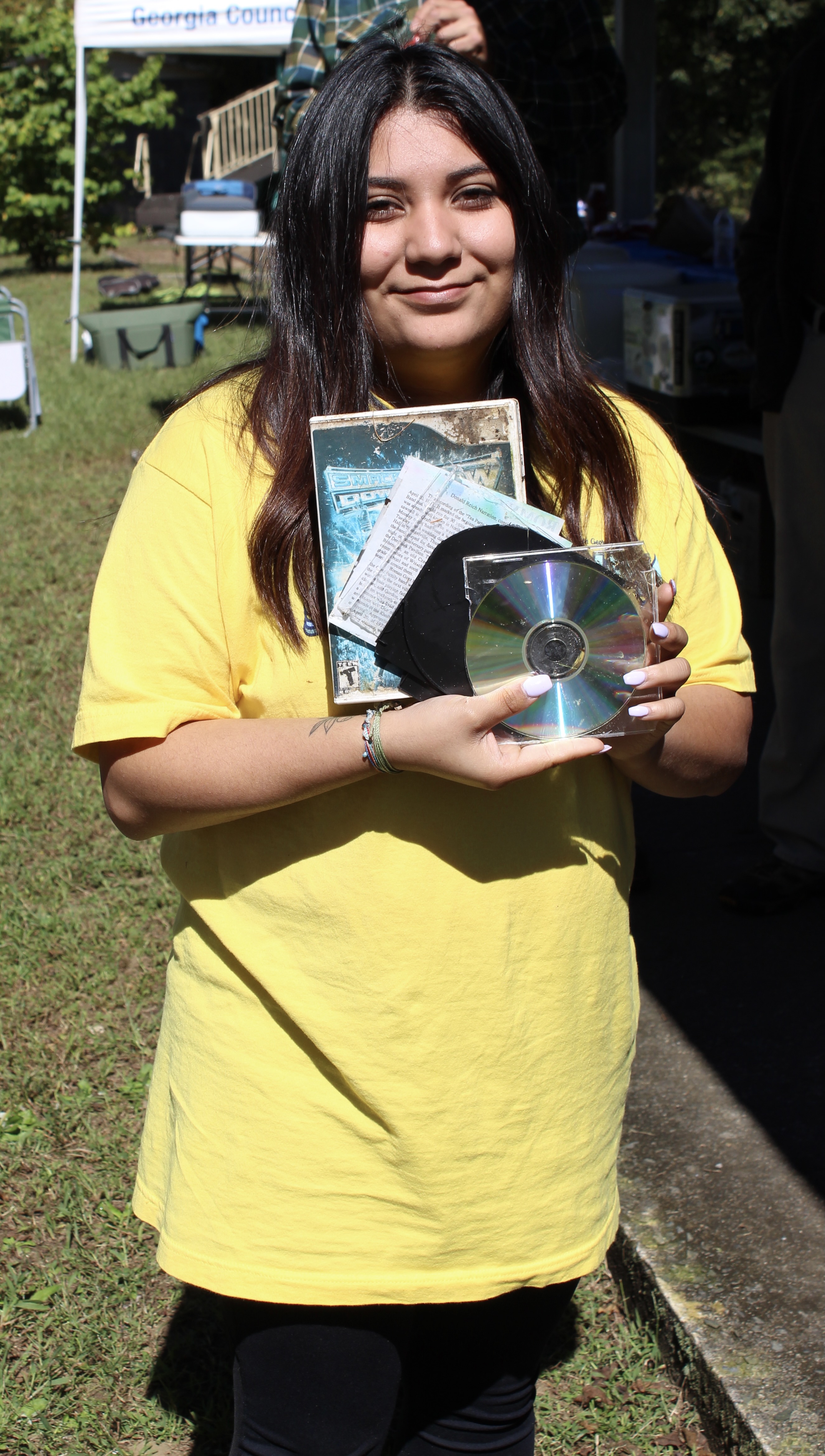 Macy Ruiz, a University of North Georgia student, won the prize for most unusual trash with an old video game and a CD and case found in multiple pieces along the upper section of the Toccoa River. 
