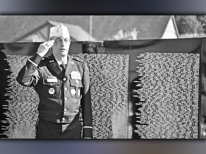 Manny Lozano, retired U.S. Army First Sergeant, salutes the American flag during a presentation of The Vietnam Traveling Memorial Wall that came to Blue Ridge in 2019.