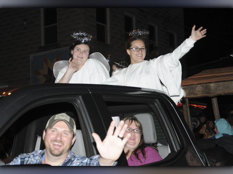 Angels Ella Nicholson, left, and Mary Beth Wells, along with Youth Director Chad Nicholson and Rachel Buller from Mine City Baptist Church, wave to the parade crowd in Ducktown.