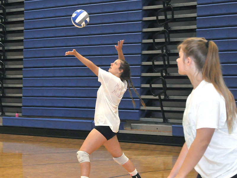 Alayna Dockery tosses the ball up for a serve during an exhibition match for the team tournament Thursday, July 14. 