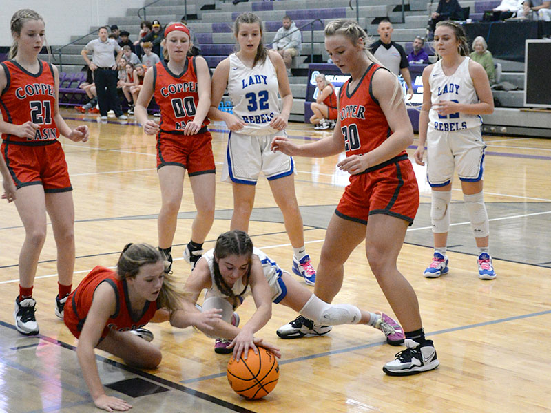 Kendra Deal of the Lady Cougars and Courtney Davis of the Lady Rebels dive on the ground for a loose ball while Alexis Hyatt (Basin, 21), Cora Kimsey (Basin, 00), Macy Hawkins (Fannin, 32) and Sapporiah Ross (Basin, 20) all wait to see who comes up with it.