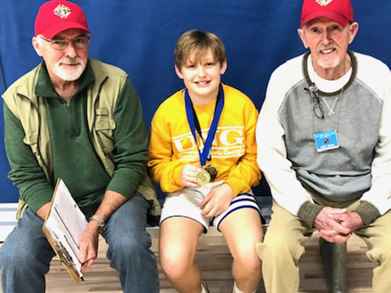 The 12 year old boys free throw winner, Garrison Ensley, is shown with Don Wirtz, left, and Bob Soph.