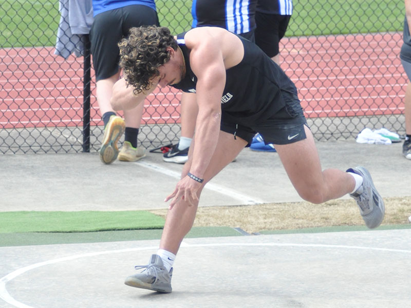 Senior Andrew Waldrep positions himself to throw during the shot put field event Tuesday, March 28, at Coahulla Creek.