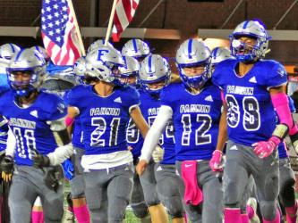 Fannin Rebels Andre Bivens (11), Treylyn Owensby (21),  Luke Holloway (12), and Jalen Ingram (88) lead the Rebels on the field before the game against the North Hall Trojans Friday, October 18.