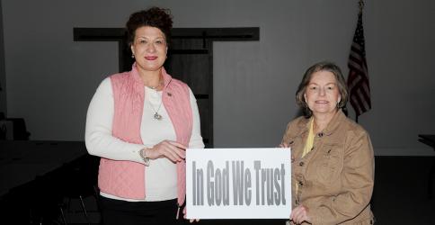 B. Alison Sosebee, left, and Sherry Morris display one of the signs meant to convey messages of help and hope during the COVID-19 pandemic.