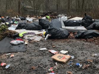 Garbage in this dump site in the Shuler Creek area of Polk County revealed the names of four Georgia residents. Those residents have been charged by U.S. Forest Service law enforcement officers and face federal penalties if convicted.