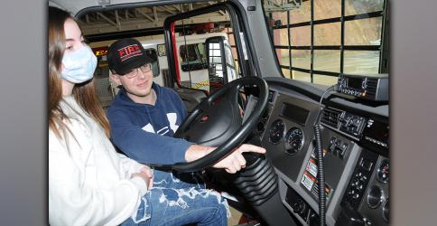 Vance Collins, one of Fannin County's newest firefighters, explains the workings of a fire engine to his sister, Jonnah. While this demonstration was not part of the class conducted for public officials, it was another example of how firefighters reach out to the public, family and friends alike, to explain everything that is included in their efforts.