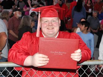 Class of 2021 graduate Ethan Carter shows off his hard-earned diploma after Copper Basin High School’s graduation ceremony Thursday, May 20. News Observer photos/Caleb Collins
