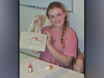 Jaelyn Breaux shows off her work during Pleasant Hill Baptist Church’s Vacation Bible School Wednesday, June 9.