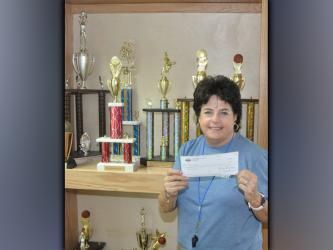 Lorraine Panter is shown with a donation to the Fannin County Recreation Department that was given from the Atlanta Hawks and Georgia Recreation and Parks Association. The $1,750 donation went to helping the kids in the Summer Camp program and was used to go to movies, waterparks, bowling and other activities.