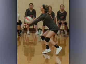 Gracie Smith makes a dig to keep the volley going after a spike from the Lady Patriots during the Lady Cougars game against Chattanooga School for the Arts and Sciences Thursday, August 19.