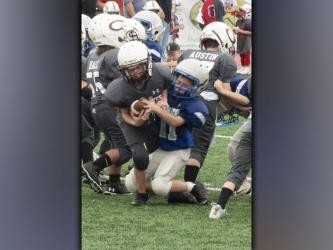 Job Conklin bust through the line of scrimmage for a big sack during the Fannin County recreation center’s football jamboree Saturday, August 21.