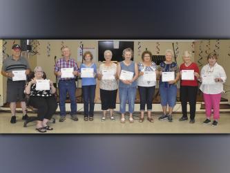 On Friday, August 13, at the Copper Basin Community Center, 10 more Polk County senior citizens graduated after completing 15 hours of computer training. This brings the total to 21 seniors who have completed the training thus far, and each one received a new Chromebook. Shown holding their certificates of completion are, from left, Don Thomas, Barbara Thomas, Wayne Loudermilk, Sarah Loudermilk, Betty Jo Hughes, Beverly Whitmer, Marieda Trammell, Dorothy Jeanette Callihan, Linda Haney and Joyce Reid. 