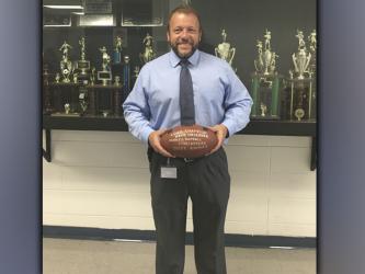 Fannin County High School principal Scott Ramsey shows off his 2020 News Observer Fearless Football Forcasters football he received for beating all other forcasters in last years football contest. Ramsey hopes to be crowned champion again this season.