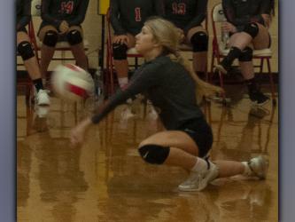 Makenna Miles digs to keep a volley alive in recent action for the Lady Cougar volleyball team.