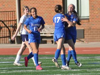 Lady Rebel Emma Richardson smiles wide and celebrates with teammate Cali Tuggle (#17) and Stephanie Kirk (#13) after scoring a goal against Haralson County Thursday, April 14. The Lady Rebels won the game 9-0 and will continue to the second round of the state playoffs Wednesday, April 20.