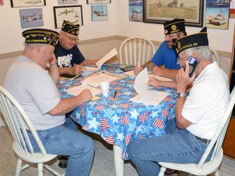 Jim Cantrell, Chris McKee, Howard “Catfish” Adkins and Ronnie Rabun, from left, call fellow members of American Legion Post #248 as part of the Legion’s Buddy System. The team gathered at the Veterans Conference Center in Blue Ridge last week to complete the mission.