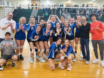 The Lady Rebels volleyball team smile and hold up the “W” after their big Region Championship win against Murray County. Shown are, from left, front row, kneeling manager Ian Delashmitt, Rylee King and Lexi Gravely; middle row, Bailee Stiles, Maggie Ledford, Maddie Pelfrey and Kaylie Davenport; and back row, coach Todd Geren, Kendall Clore, Maddie Usry,  head coach Heather Ades, Ava Queen, Peyton Slone, Cali Tuggle. Alanya Dockery, coach Sam Walker and manager Michael Stephens. 