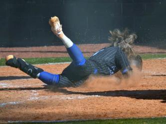 Carson Callihan slides into home plate for an “in-the-park” home run Saturday, March 18.