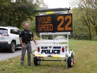 Blue Ridge Police Chief Robbie Stuart stands with the department’s new “eyes,” a portable speed detection/traffic control message board. It was in use on Church Street last week.