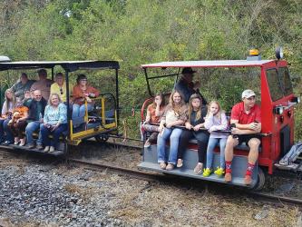 Shown are guests riding motor cars down some of Fannin County’s historic, restored railroad from the Mineral Bluff Depot during a previous Ride the Rails event.