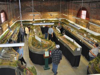  An overhead view of the Tri-State Model Railroaders “Old Line” shows how truly expansive the layout is. The layout is an “around the room” loop to loop. The model is an exact miniature replica of the Old Line Railroad that was a part of a project to link Knoxville, Tennessee, to Marietta, Georgia, by rail. 