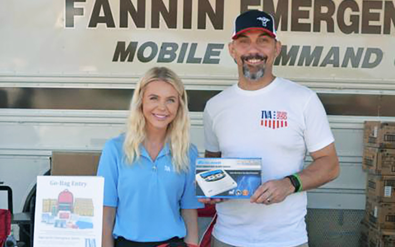 News Observer photo/Mollie Morrow - TVA's Government & Community Relations Specialist Kayleigh Heaton and Senior Strategic Communicator Tom Satkowiak give out weather radios during the event held in partnership with Fannin County EMA July 18 at the EMA headquarters.