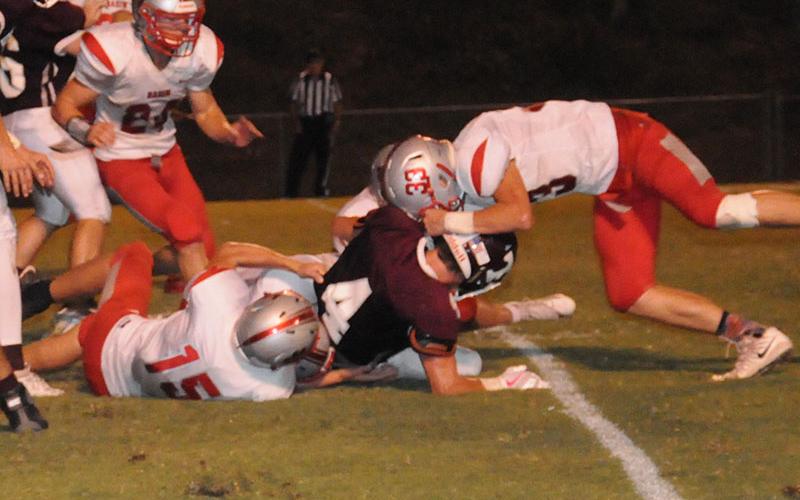 Copper Basin Cougar Chase Mickens (24) rushes to help Joe Boggs (15) and Timothy Fair (33) tackle a Tellico player during the Cougars win Friday, September 13.