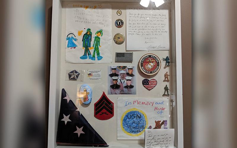 In Tracie Griffith’s office hangs a shadow box dedicated to the five fallen soldiers who were killed in an active shooter terrorist attack at their Reserves base in Chattanooga, July 16, 2015. The men were good friends with Griffith’s son who is also a Marine.