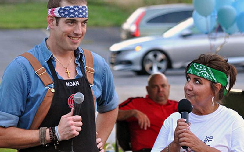 Fannin County’s Noah Sims was a contestant on Fox network’s MasterChef Season 10 television show and made it to the top four home chefs. Blue Ridge Mayor Donna Whitener helped organize a Noah Night watch party in the downtown park September 11. Shown are Sims and Whitener speaking with the folks who came to watch the show.