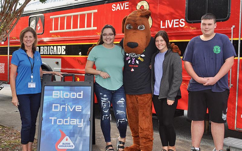 Fannin County High School students donate blood through Blood Assurance to help save lives Friday, September 20. Shown are, from left, teacher Anne Gibbs, Olivia Lowman, Trevor Couch as Hero, Mattie Prince and Caleb Couch.