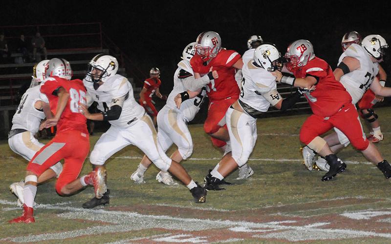 Copper Basin Cougars Cody Montgomery (85), Addison Hook (61) and Hunter Perry (78) get into the backfield and pressure the quarterback during Copper Basin’s region win against Lookout Valley Friday, October 4.