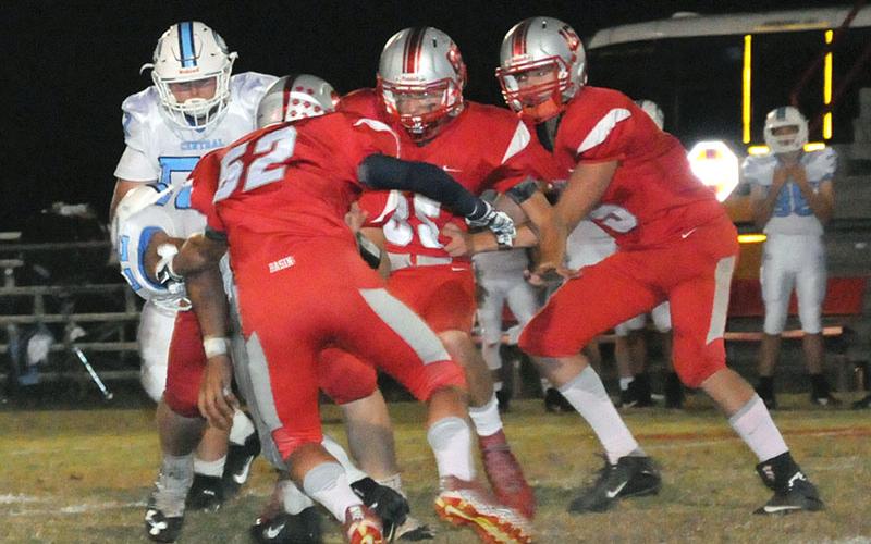 Copper Basin Cougars Larry Dye (52), Cody Montgomer (85) and Joe Boggs (15) wrap up a McMinn Central runner during Copper Basin’s game against the Chargers Friday, October 11.