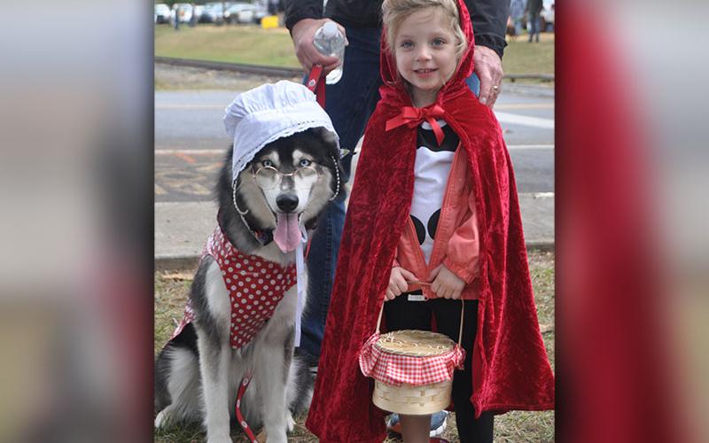 Little Red Riding Hood, Claire, and Big Bad Wolf, Mila, took a break and were all smiles during the annual Paws in the Park in downtown Blue Ridge, Saturday, October 19. Heavy rains didn’t dampen spirits for the annual event that included a parade and dock diving dogs.