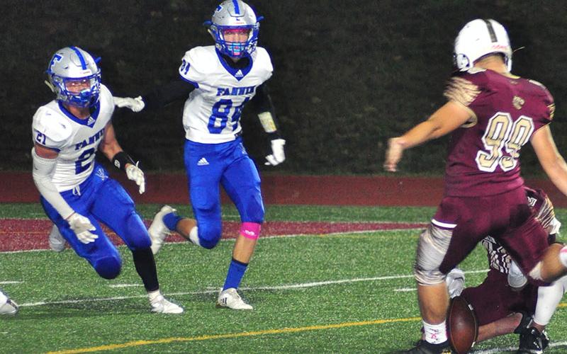 Fannin Rebels Treylyn Owensby (21) and JoJo Goodwin (84) rush to block a field goal during the Rebels region game with the Dawson County Tigers Friday, October 25.