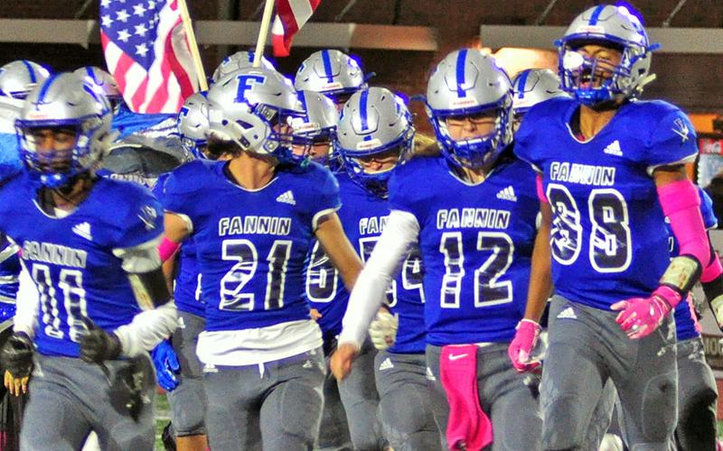 Fannin Rebels Andre Bivens (11), Treylyn Owensby (21),  Luke Holloway (12), and Jalen Ingram (88) lead the Rebels on the field before the game against the North Hall Trojans Friday, October 18.