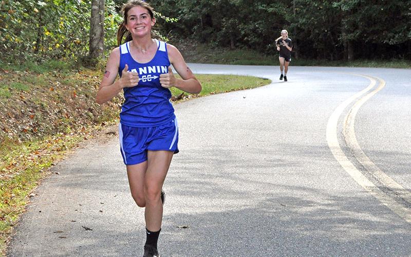 Lady Rebel cross country runner Monica Cosentino smiles as she competes in recent action for the Lady Rebels cross country team.