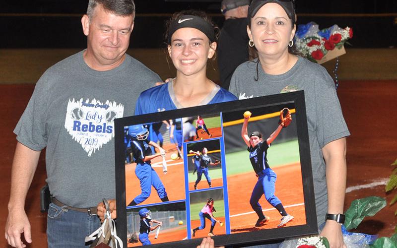 The 2019 Lady Rebel softball seniors were honored after their last home game of the season Thursday, September 26. Senior Lady Rebel Kaelyn Hensley is shown with her parents Jamie and Faith Hensley.