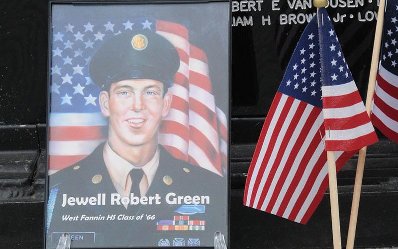 A photo of Jewell Robert Green and a United States Marine Corps coin were at the base of the Vietnam Memorial Traveling Wall Sunday, no doubt placed quietly by those who remembered sacrifices.